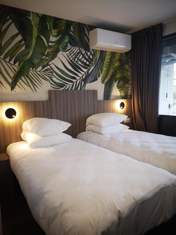 Postel nebo postele na pokoji v ubytování O'Cub Hotel