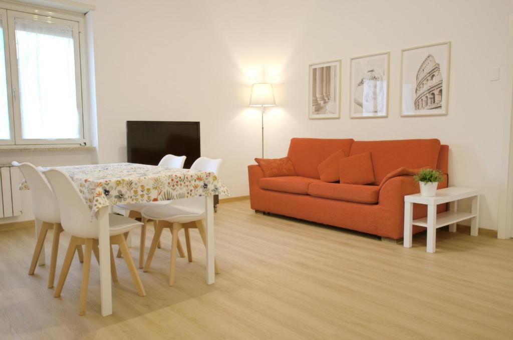 sala de estar con mesa y sofá en Cornelia IDI Gemelli, Chicca Metro Apartment, en Roma