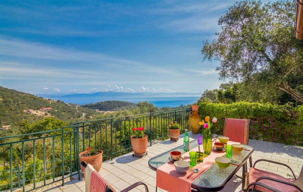 a patio with a table and chairs on a balcony at Villa Melissa Paxos in Bogdanátika