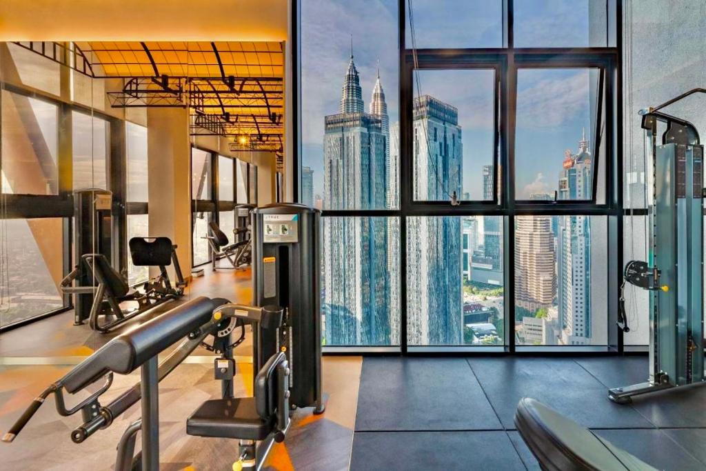 a gym with a view of the empire state building at Scarletz Suites KLCC by M Suites in Kuala Lumpur