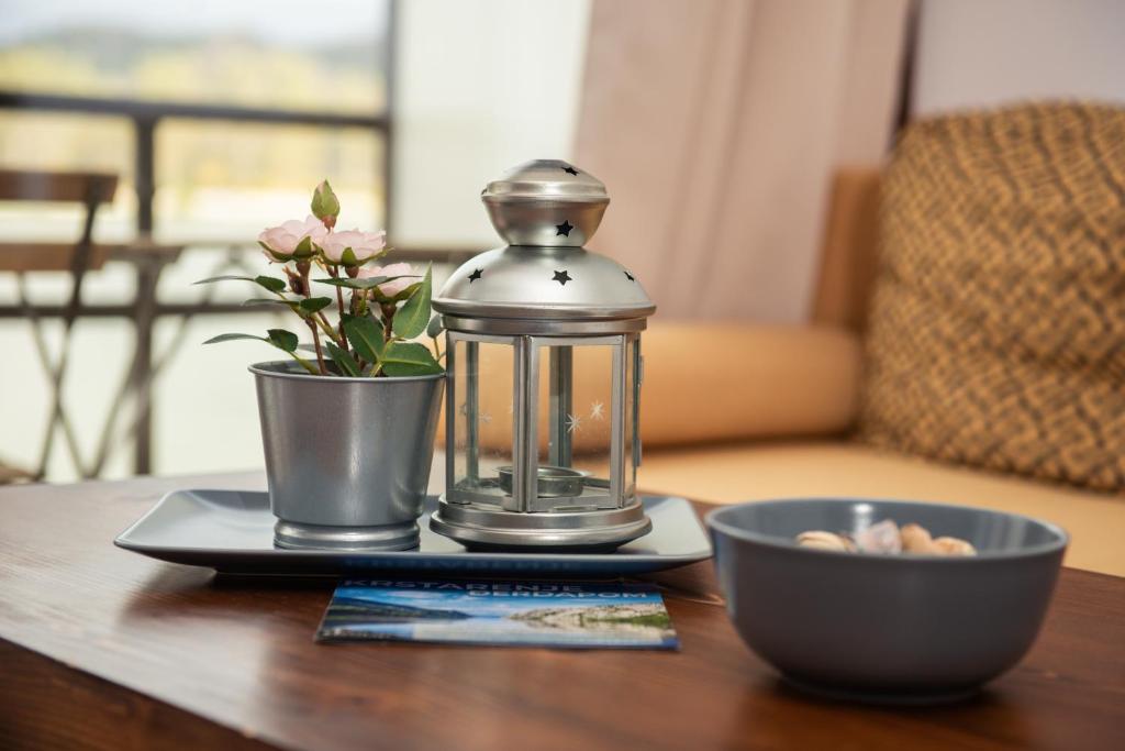 a glass lantern and a bowl on a table at Boatel Copacabana in Veliko Gradište