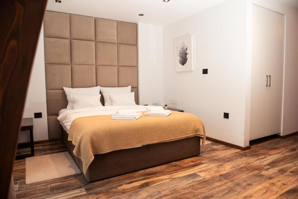 a bedroom with a large bed with a large headboard at Boatel Copacabana in Veliko Gradište
