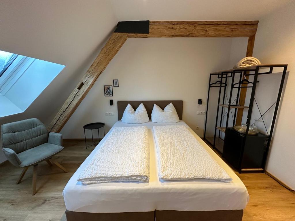 a bedroom with a large bed in a attic at Gasthof - Auszeit im Bad Diezlings - Adults only in Hörbranz