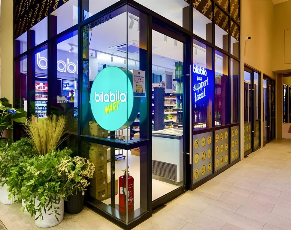 a store front of a drugstore with a sign in the window at Scarletz Suites KLCC by M Suites in Kuala Lumpur