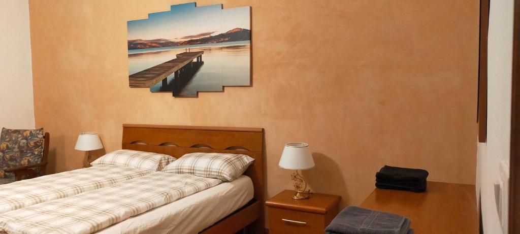 a bedroom with a bed and a picture of a pier at Appartamento Rosa in Marghera
