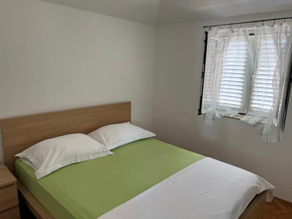 Postel nebo postele na pokoji v ubytování Apartman Belamarić