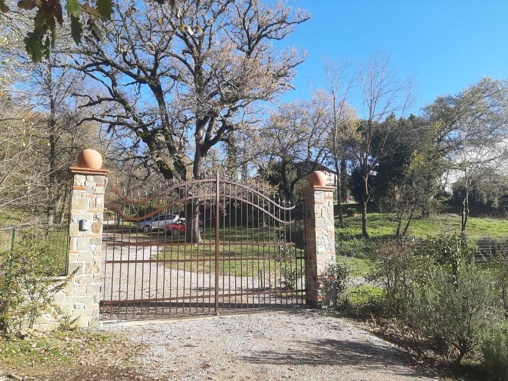 an iron gate with a slide in a park at AGRITURISMO Casale Il Caggio in Ciggiano