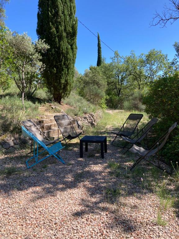 duas cadeiras e uma mesa azul num campo em Le refuge em La Verdière