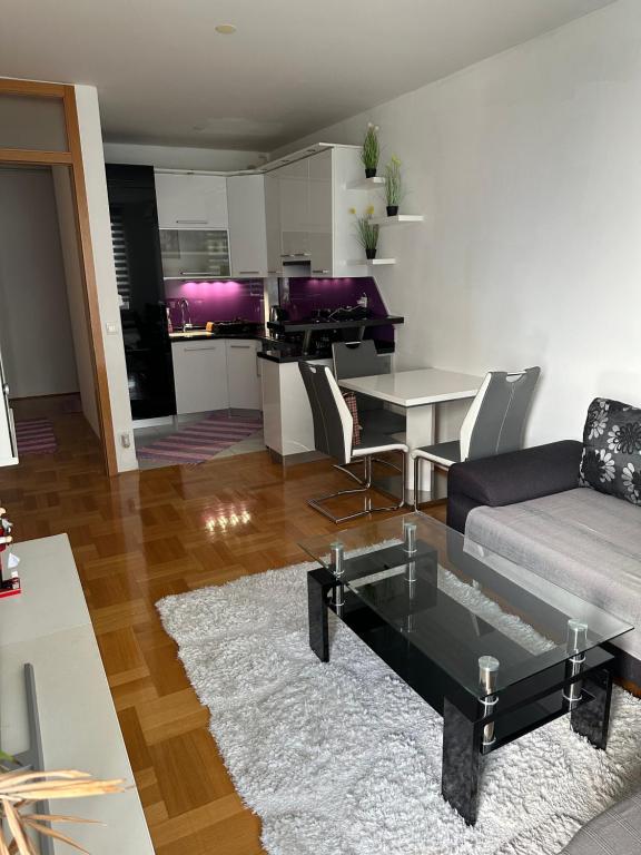 un soggiorno con divano e tavolo di Pia Apartment -SelfCheckIn-free parking a Zagabria