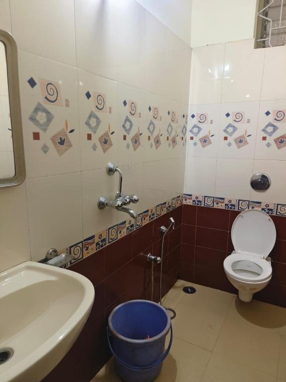 a bathroom with a toilet and a sink at Flagship La Grande Residencya in Old Goa