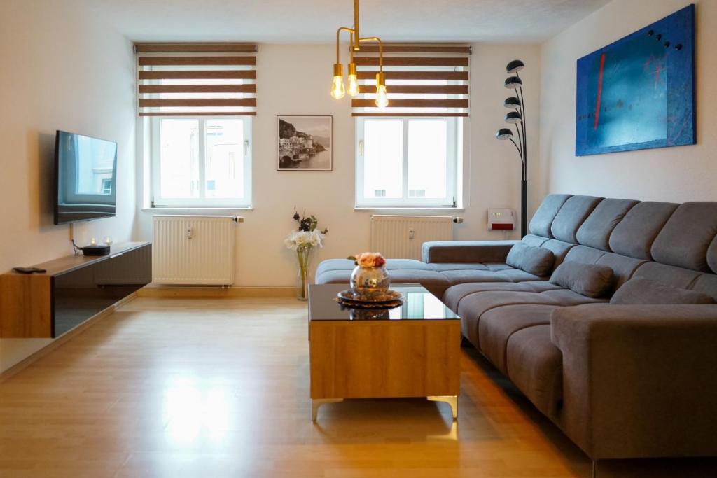 a living room with a couch and a coffee table at 3-Raum City-Appartement Jena in Jena