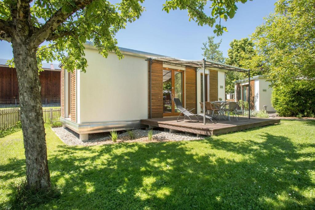 a home with a deck and a yard at Ferienhaus Im Tobel in Deggenhausertal