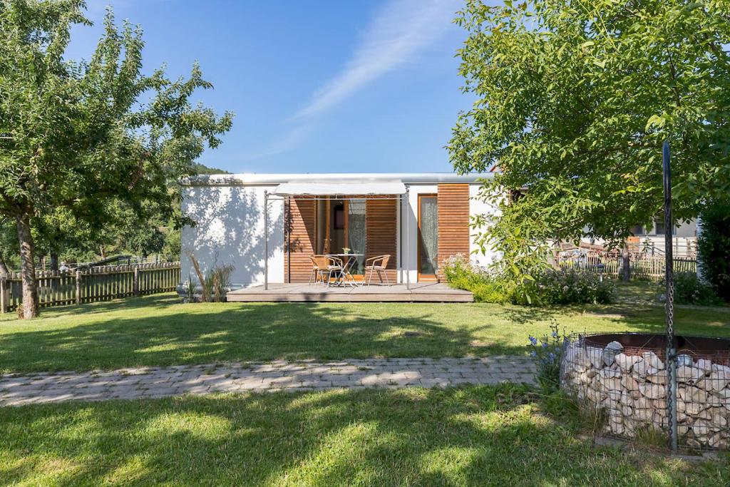 a small house with a patio and a yard at Ferienhaus Am Sedelbach in Deggenhausertal