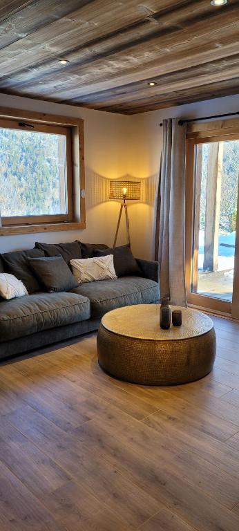 a living room with a couch and a table at Les petites chambres St Gervais in Saint-Gervais-les-Bains