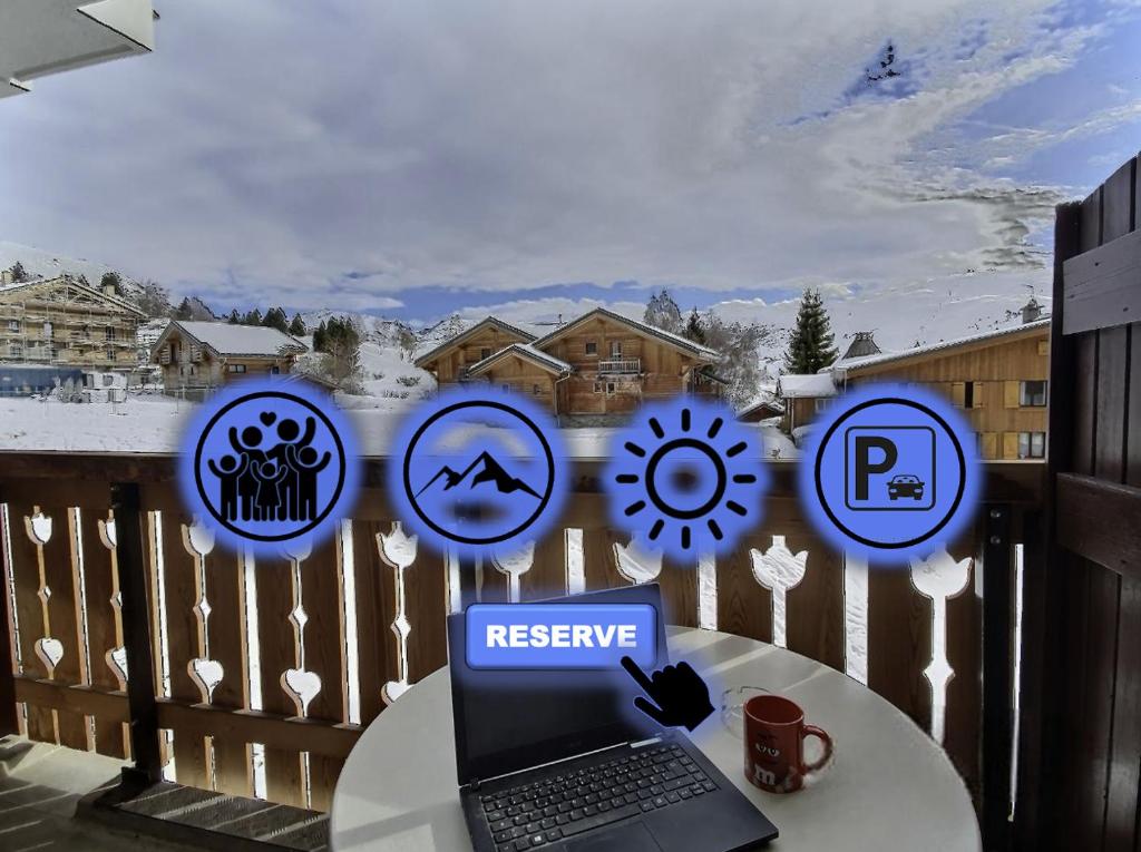 a laptop computer sitting on a table on a balcony at Pieds des pistes - Parking couvert - Plein sud in L'Alpe-d'Huez