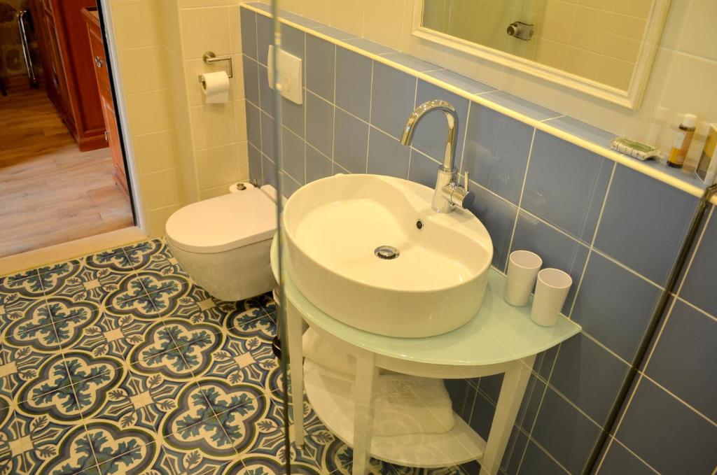 
a bathroom with a sink, toilet, and bathtub at Hotel Ellique in Rhodes Town
