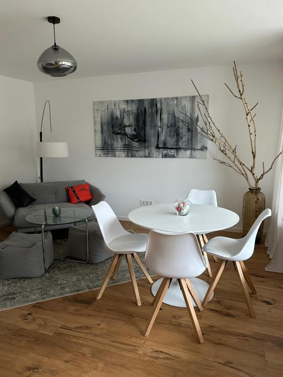 a living room with a white table and chairs at Sweet Home in Meerbusch in Meerbusch