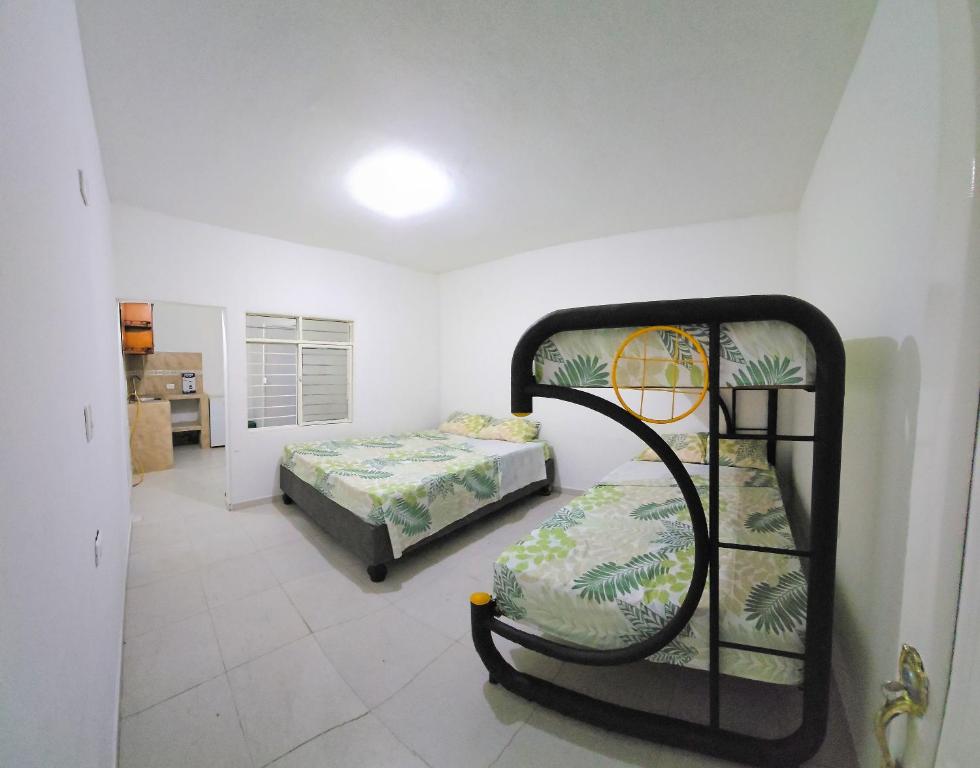 two bunk beds in a room with a bedroom at FAMILY HOUSE CN in Cali