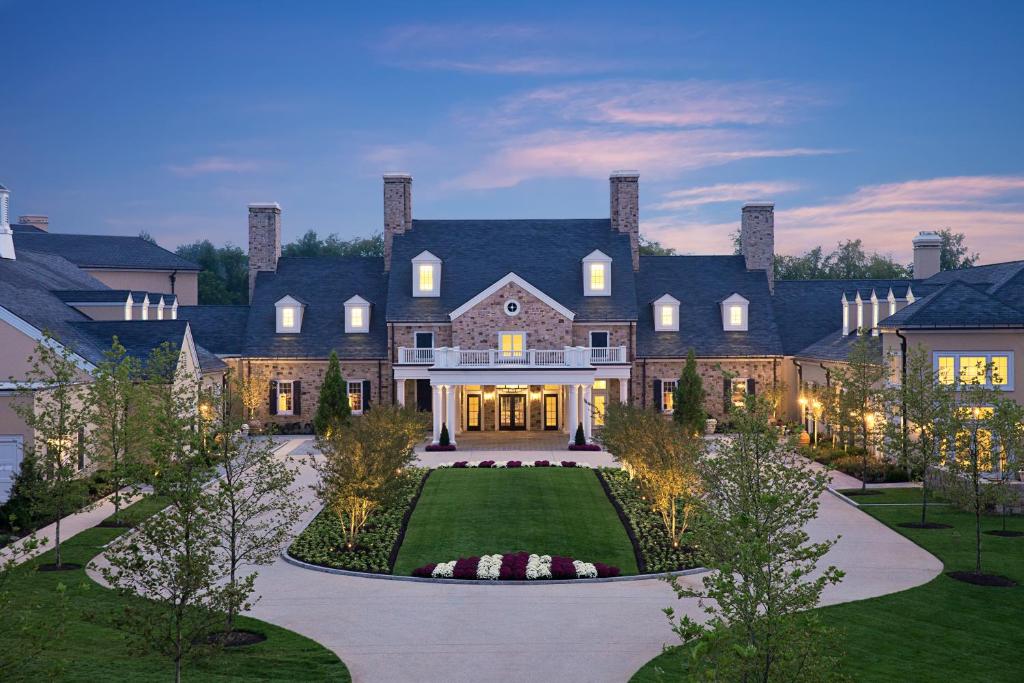 a large house with a landscaping in front of it at Salamander Resort and Spa in Middleburg