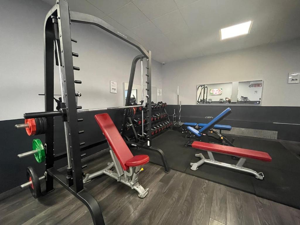 a gym with red and blue chairs in a room at Defoy Getaway - Antibes in Antibes