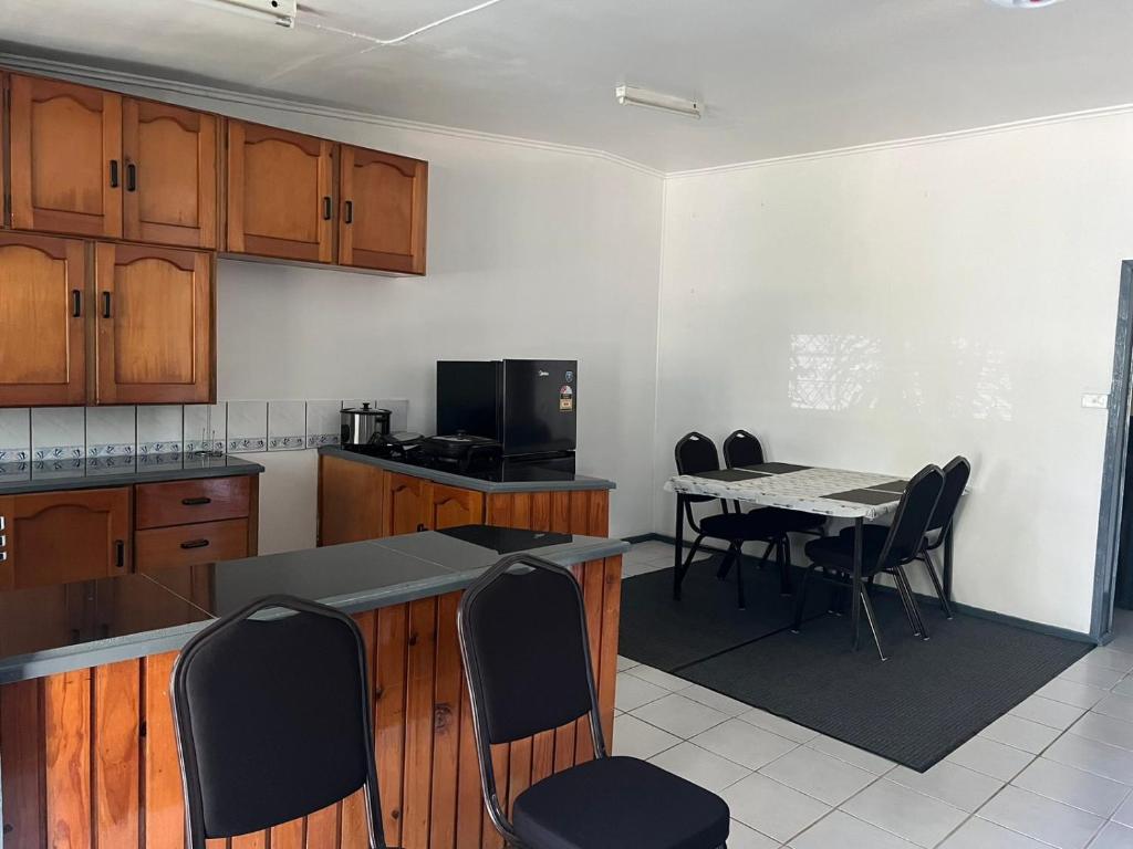 a kitchen with a table and chairs and a dining room at Ziara Apartments in Nadi