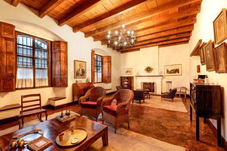 a living room filled with furniture and a fireplace at Eternal Spring in Antigua Guatemala