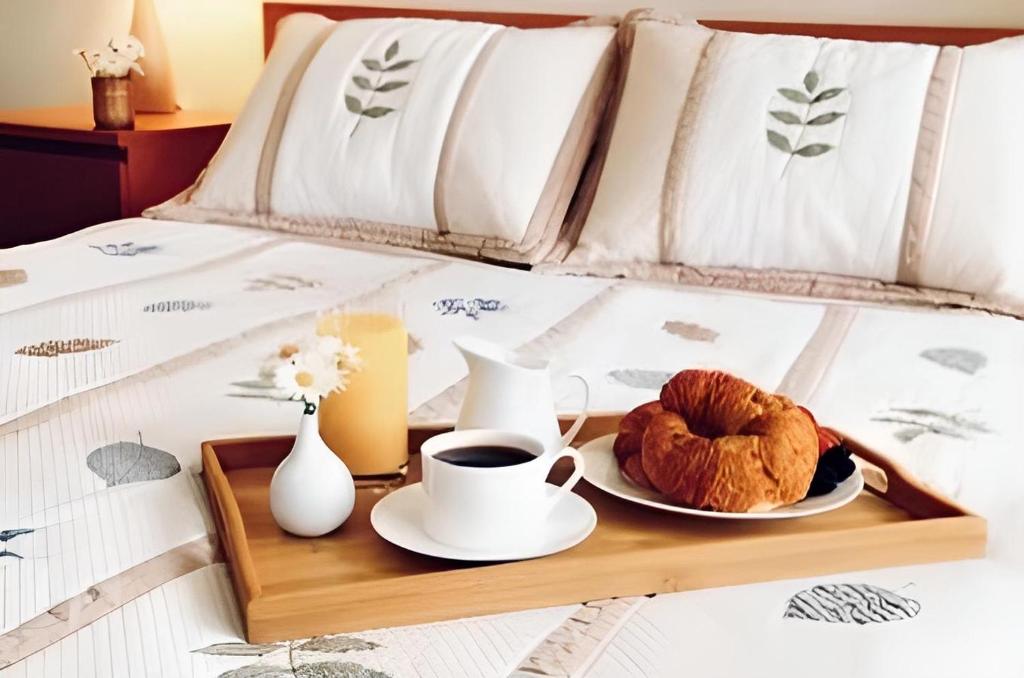 a tray with a cup of coffee and croissants on a bed at Panorama Inn in Rio de Janeiro