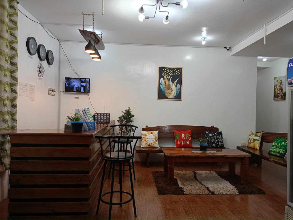 a living room with a couch and a table at Alec Lodge in Coron