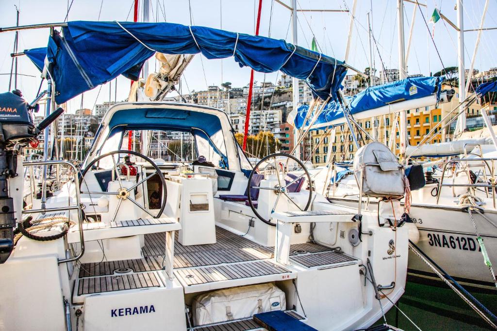 a boat docked in a harbor with other boats at Barca a vela Kerama - Smart Wind in Naples