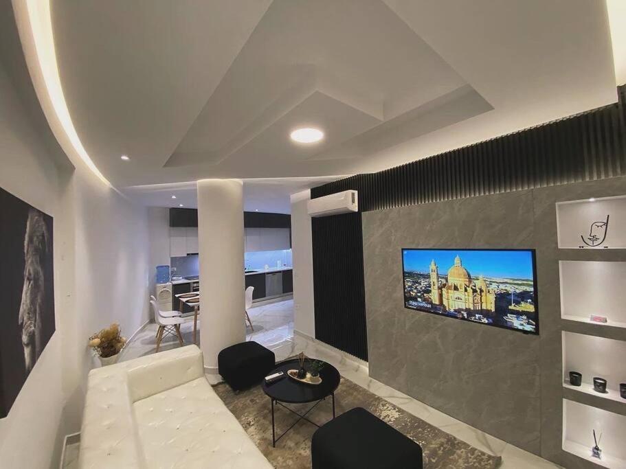 a living room with a flat screen tv on a wall at Suncity Tirana Luxury Apartments (Ap. 01) in Tirana
