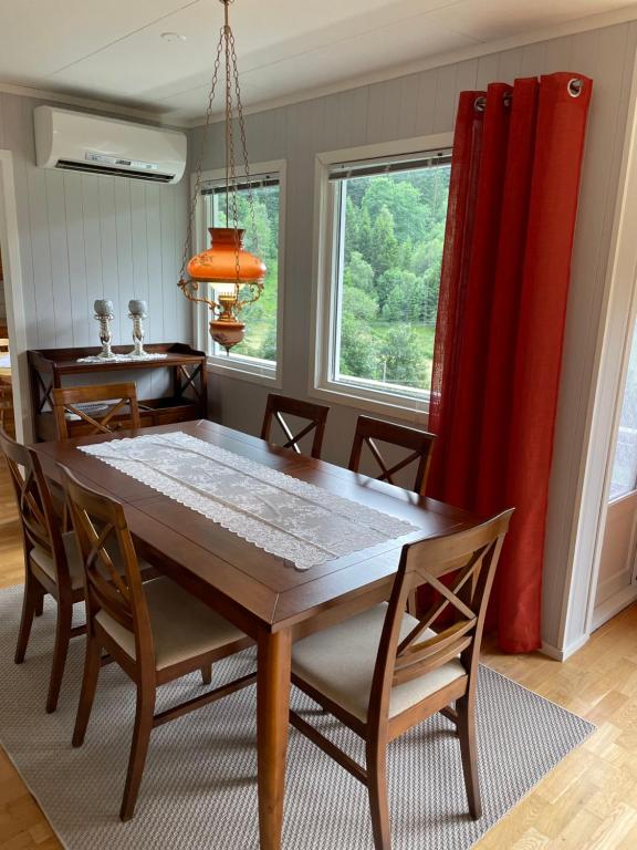 a dining room with a wooden table and chairs at Tunold Gård - Olahuset in Oppstryn