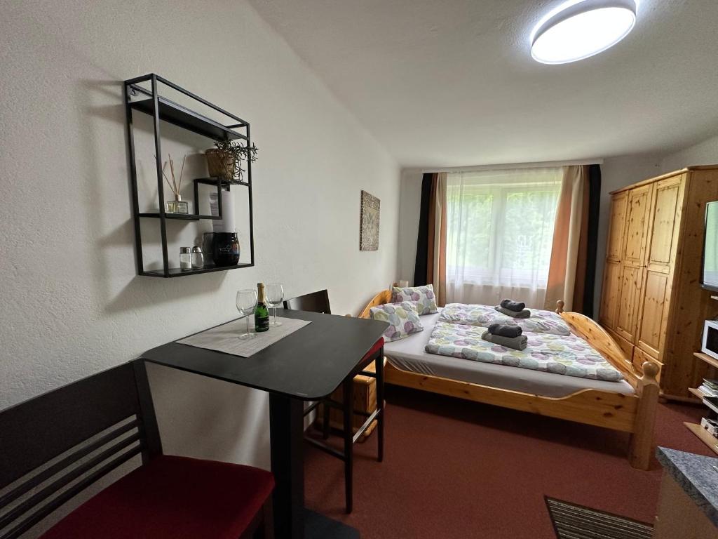 a small room with a bed and a table in it at Dachsteinblick apartment in Ramsau am Dachstein