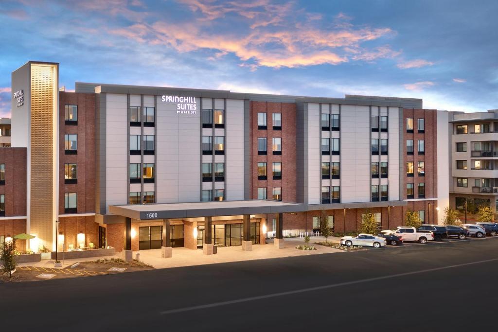 a rendering of a building with cars parked in a parking lot at SpringHill Suites by Marriott Phoenix Scottsdale in Scottsdale