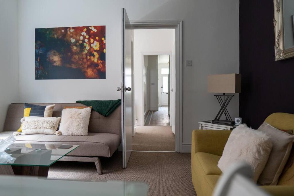 a living room with a couch and a table at Central 6Bed Retreat - Your Perfect Coventry Holiday Home Away in Coventry
