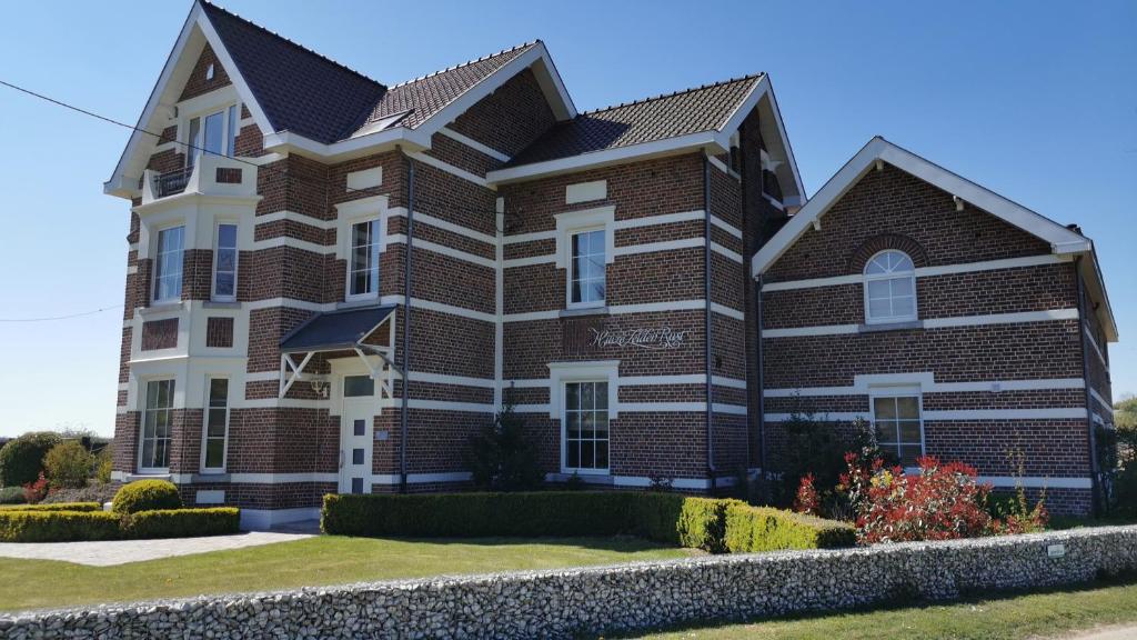 a large brick house with a roof at Aan de Keiberg in Bilzen