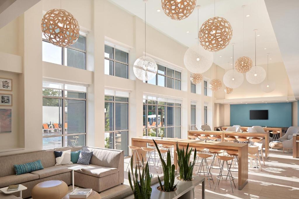 a large room with tables and chairs and chandeliers at Element Orlando International Drive in Orlando