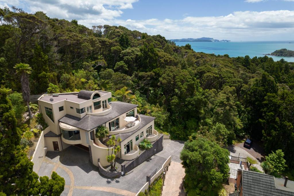 an aerial view of a house with the ocean in the background at Bayview Panorama - Paihia Holiday Home in Paihia