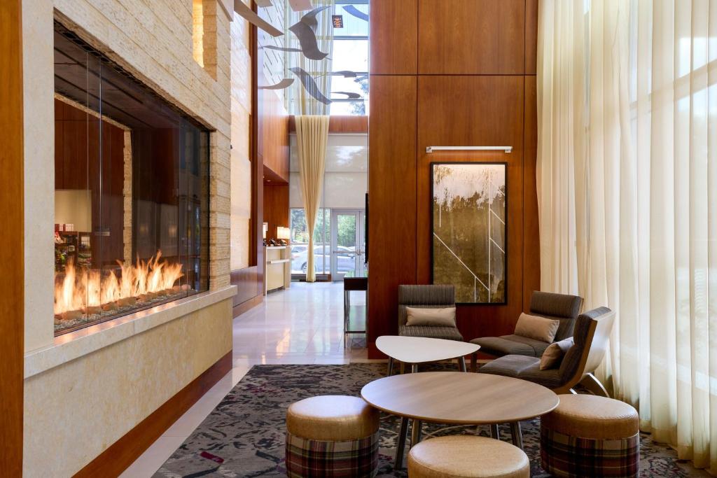 a lobby with two tables and a fireplace at Residence Inn Arlington Capital View in Arlington