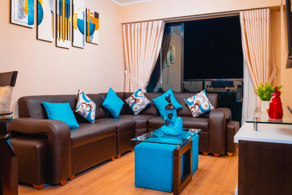 リマにあるApartamento de Ensueño LINCEのリビングルーム(ブラウンソファ、青い枕付)
