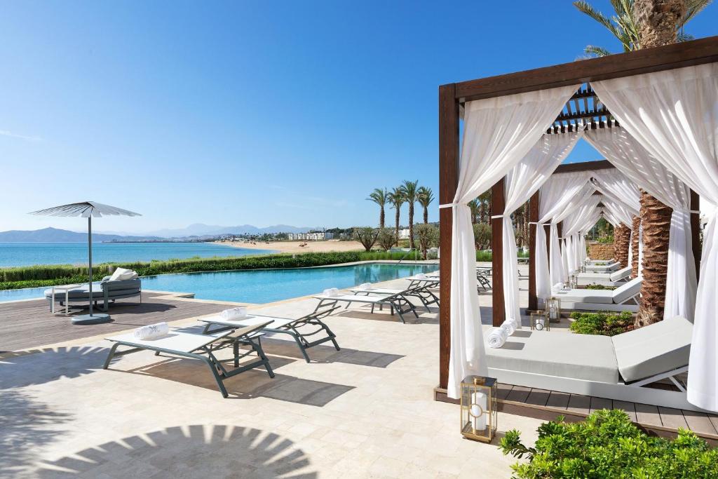 a resort with a pool and a gazebo at The St. Regis La Bahia Blanca Resort - Tamuda Bay in Fnidek