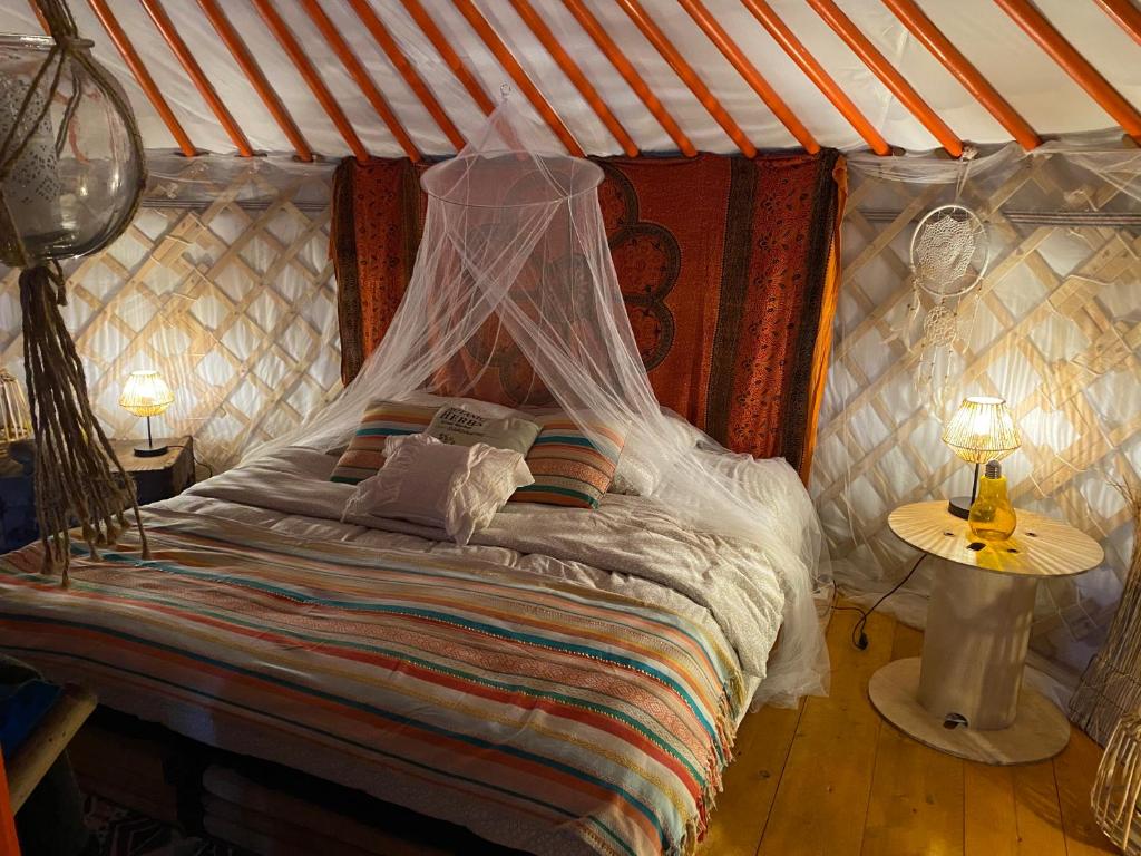 1 dormitorio con 1 cama en una yurta en Les Hôtes de Sermaize, en Bois-le-Roi