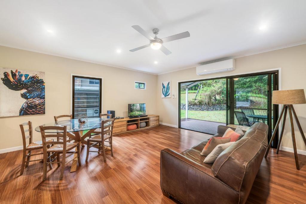 a living room with a couch and a table at Cockatoo Hideaway- Cabin in Montville