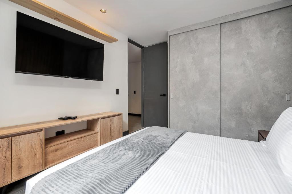 Postel nebo postele na pokoji v ubytování Apartamentos HOUSY Laureles