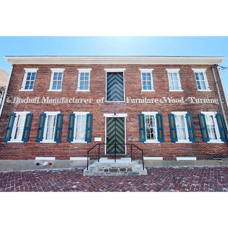 un edificio di mattoni con un cartello sulla parte anteriore di Bischoff Inn - Former 1870 Furniture Factory Now 5 Room Boutique Hotel a Tamaqua