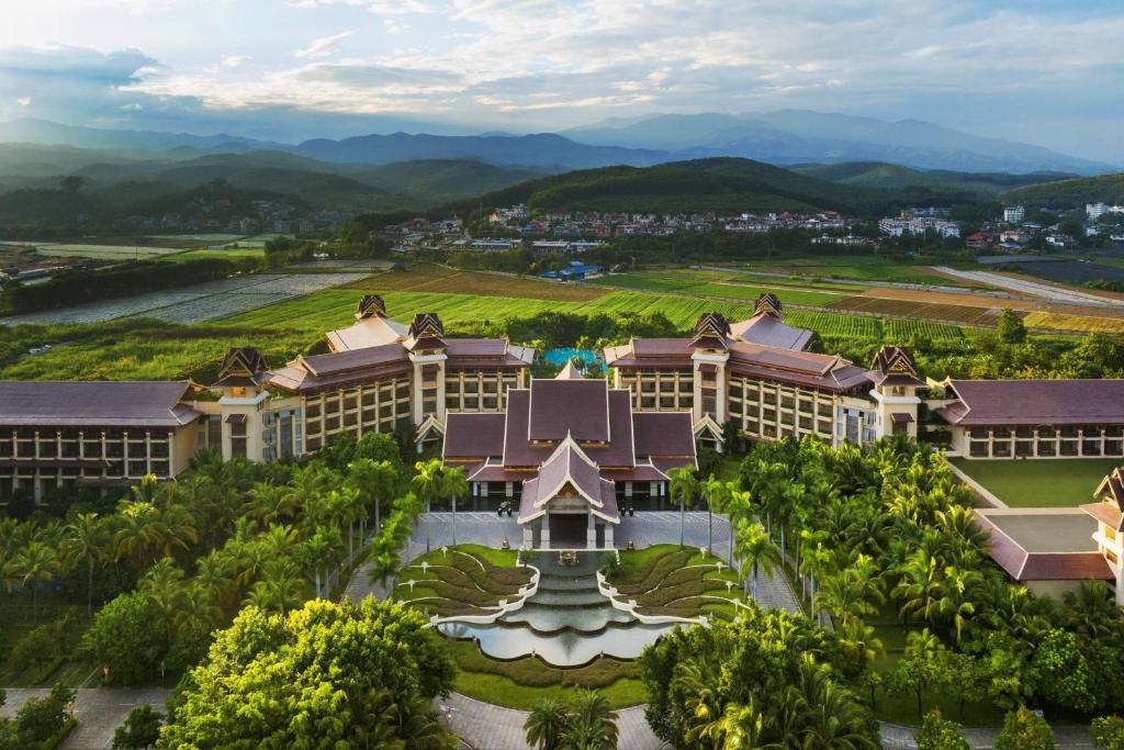 an aerial view of a resort with mountains in the background at Sheraton Grand Xishuangbanna Hotel in Jinghong