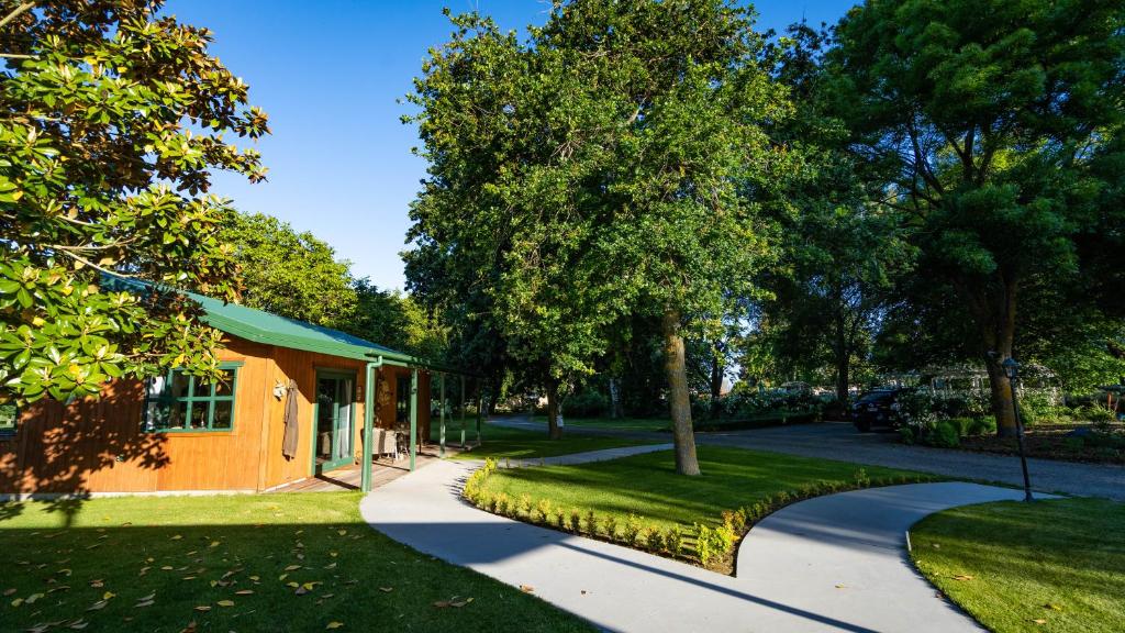 a house with a tree and a walkway at The Jolly Poacher Retreat in Blenheim