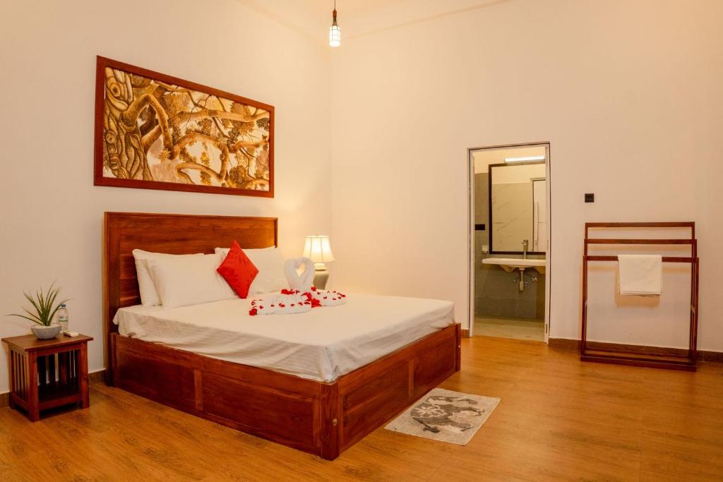 a bedroom with a bed and a painting on the wall at AGP Greeny View Resident in Galle