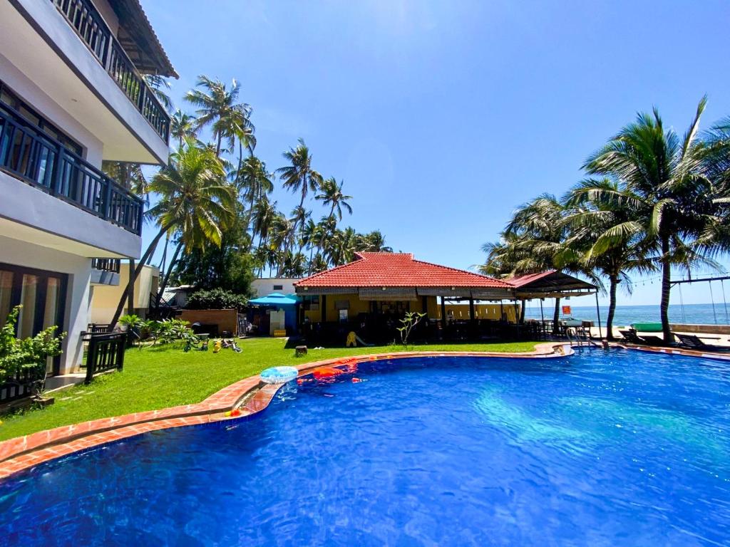 a large swimming pool in front of a resort at Venus MuiNe in Mui Ne