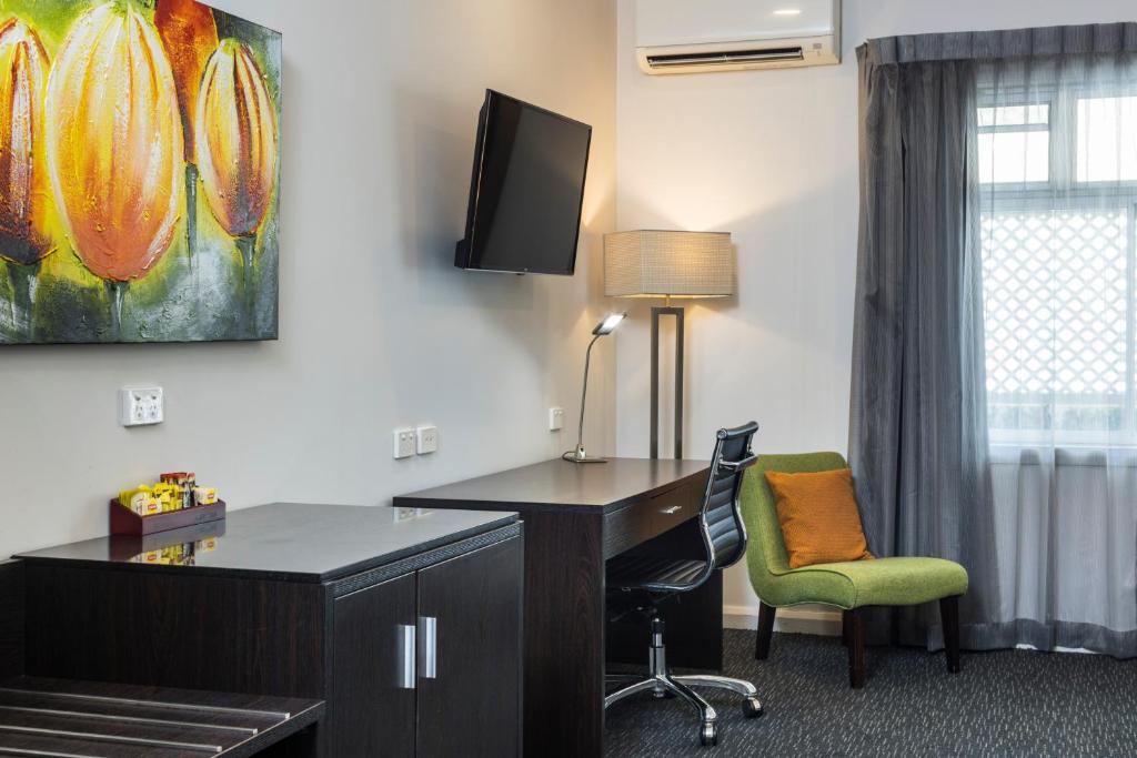 an office with a desk and a green chair at The Abbott Boutique Hotel in Cairns