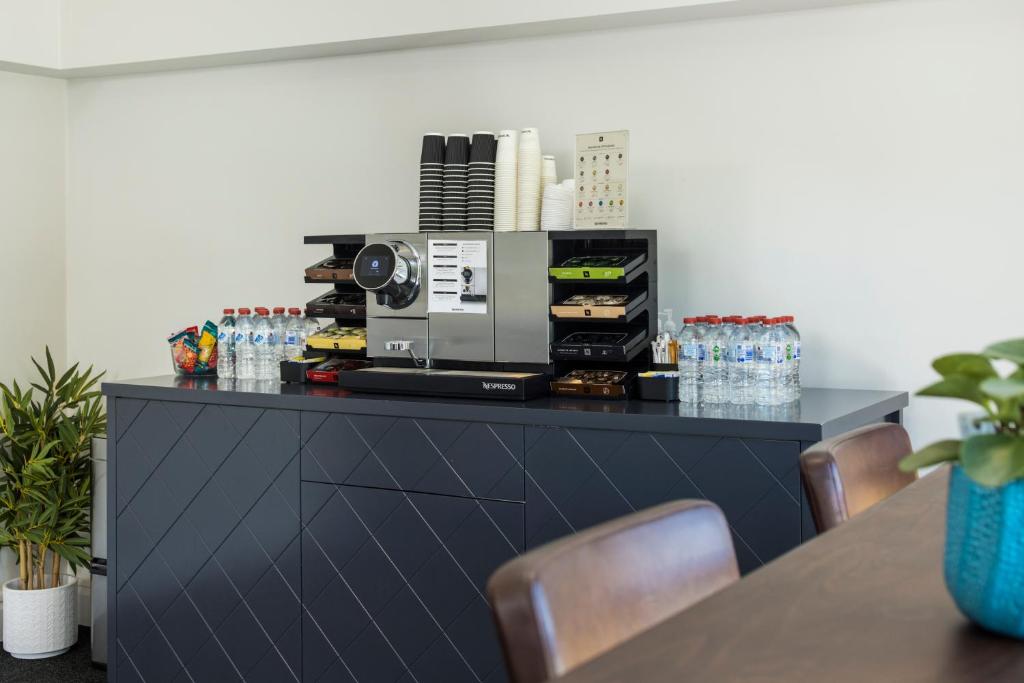 a black counter with a coffee maker on top of it at The Abbott Boutique Hotel in Cairns